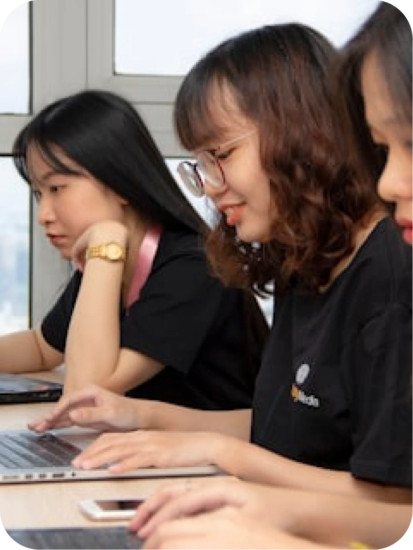 Group of young women collaborating around a laptop